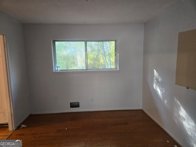 unfurnished room featuring dark hardwood / wood-style flooring