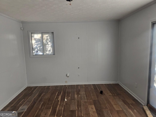 spare room featuring crown molding and dark wood-type flooring