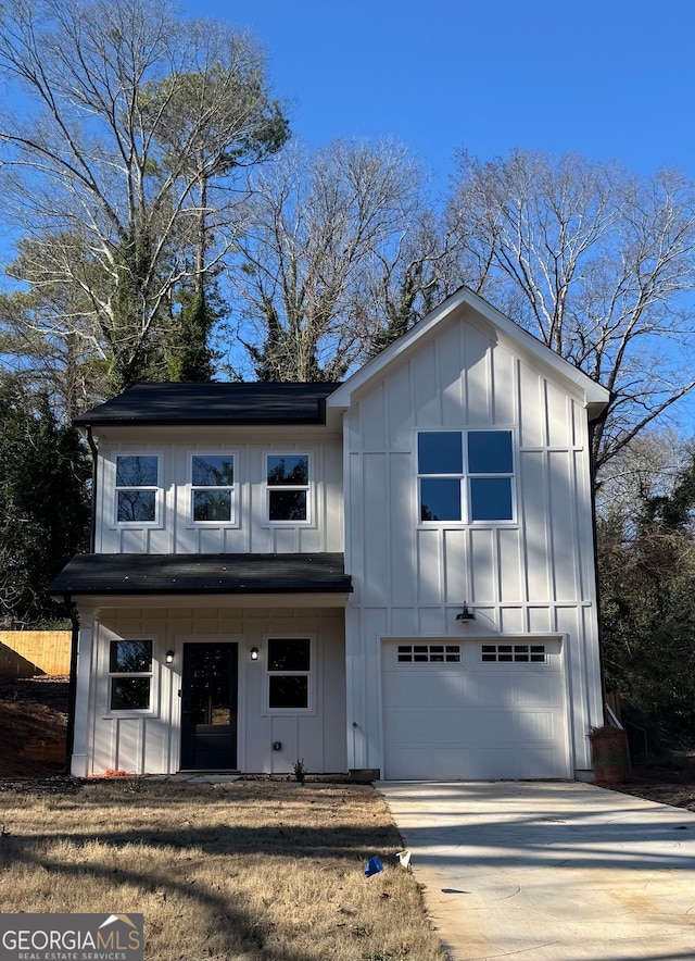 modern farmhouse featuring board and batten siding, driveway, and a garage