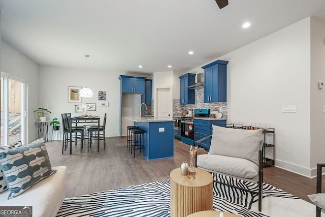 living room featuring baseboards, wood finished floors, and recessed lighting