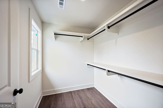 spacious closet featuring dark wood-style floors and visible vents