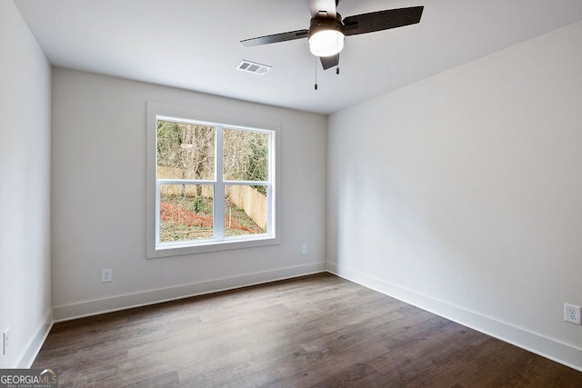 unfurnished room with a ceiling fan, baseboards, visible vents, and wood finished floors