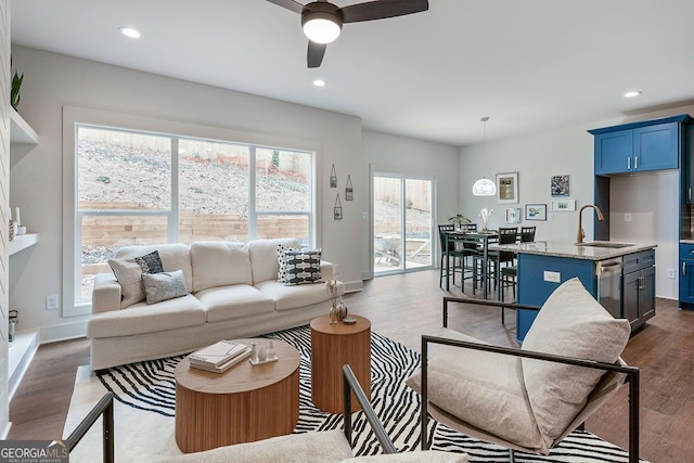 living room featuring recessed lighting, dark wood finished floors, and baseboards