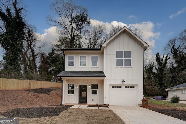 modern farmhouse style home featuring a garage, a shingled roof, concrete driveway, fence, and board and batten siding