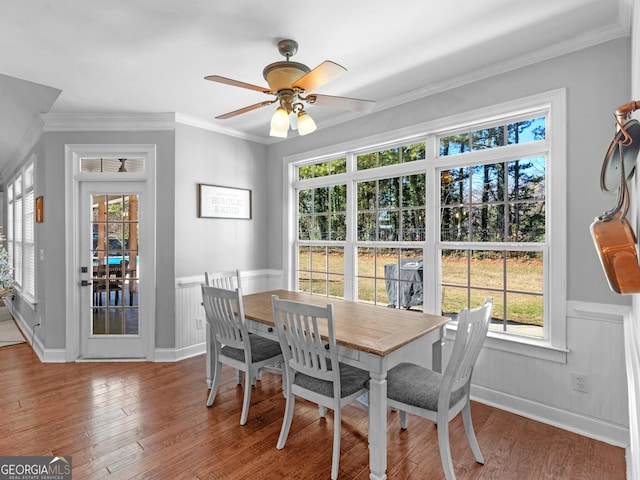 dining area featuring ceiling fan, ornamental molding, and hardwood / wood-style flooring