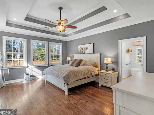 bedroom with a tray ceiling, ceiling fan, crown molding, and dark hardwood / wood-style floors