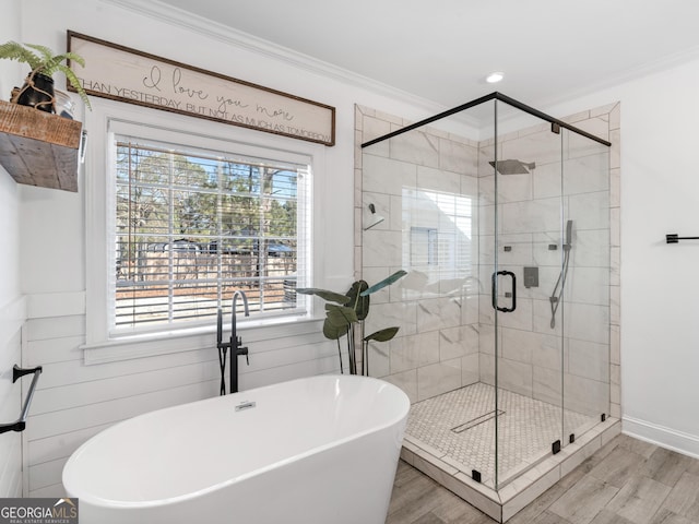 bathroom featuring hardwood / wood-style floors, separate shower and tub, plenty of natural light, and ornamental molding