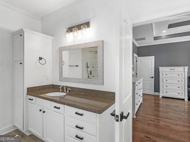 bathroom featuring vanity, hardwood / wood-style flooring, and ornamental molding