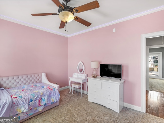 carpeted bedroom with ceiling fan and crown molding