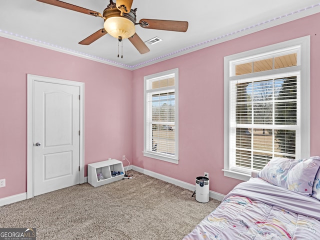 bedroom featuring multiple windows, ceiling fan, and carpet floors