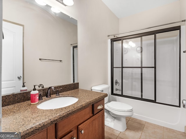 full bathroom featuring tile patterned floors, vanity, toilet, and shower / bath combination with glass door