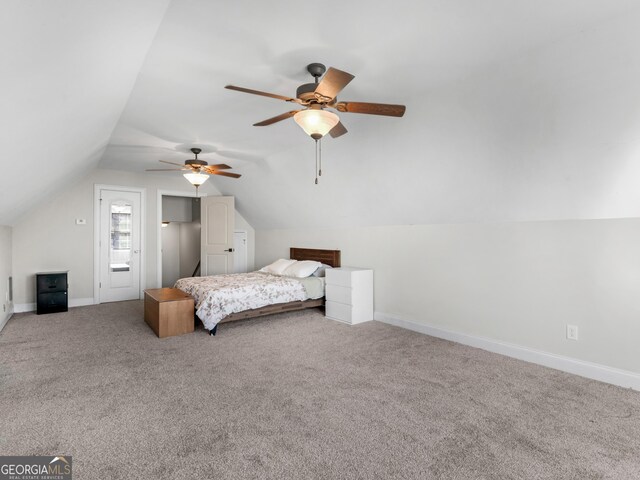 carpeted bedroom with ceiling fan and vaulted ceiling