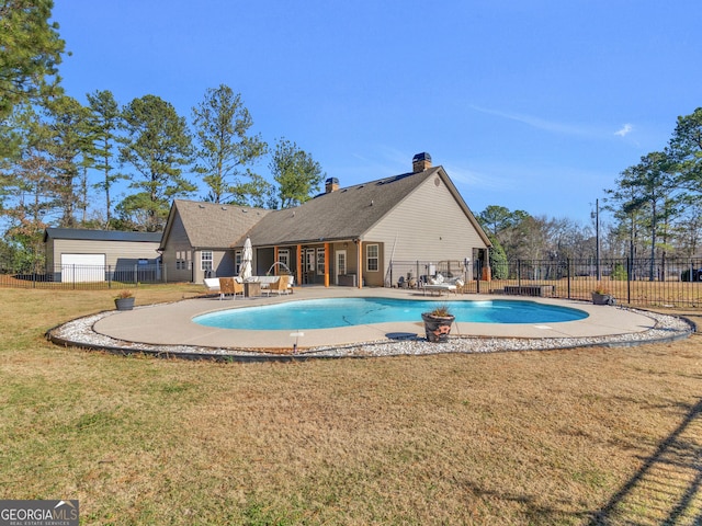 view of swimming pool with a patio area and a yard