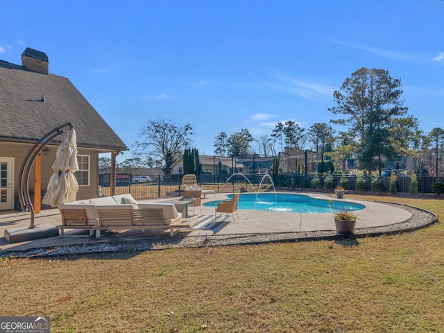 view of swimming pool with pool water feature, outdoor lounge area, a patio, and a lawn