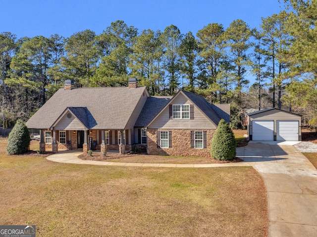 view of front facade with covered porch, a garage, a front lawn, and an outdoor structure