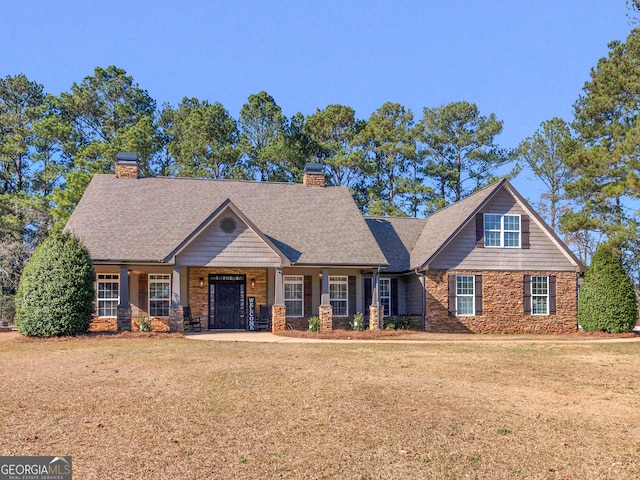 craftsman-style home featuring a front yard and covered porch