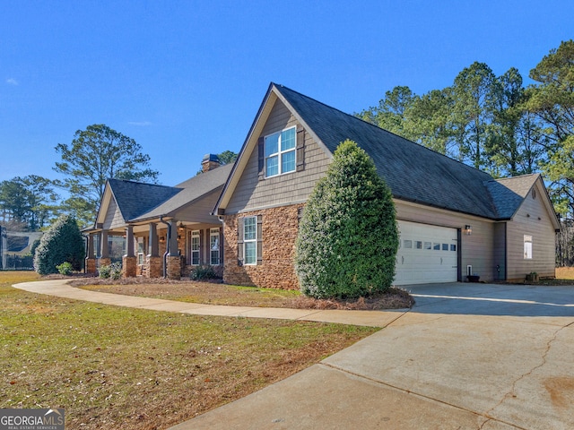 view of side of home featuring a garage and a yard