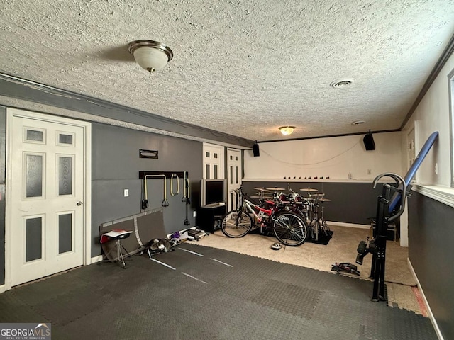 exercise room featuring a textured ceiling