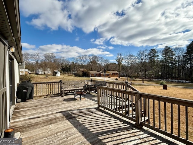 wooden deck featuring a grill