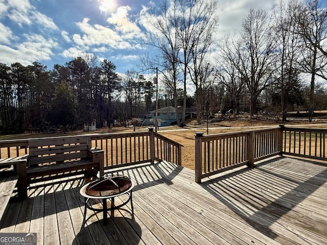 wooden terrace with an outdoor fire pit