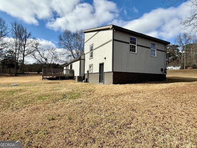 view of property exterior with cooling unit and a wooden deck