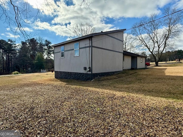 view of property exterior with a lawn