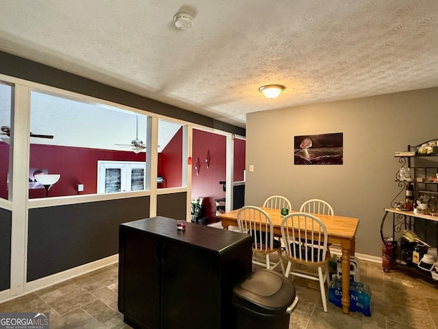 dining room with a textured ceiling and ceiling fan