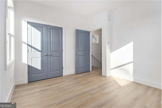 empty room featuring a healthy amount of sunlight and light hardwood / wood-style flooring