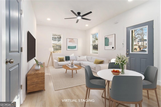 dining space with light wood-type flooring and ceiling fan