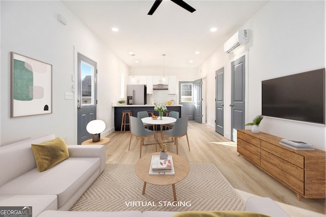 living room with light hardwood / wood-style flooring and a wall mounted AC