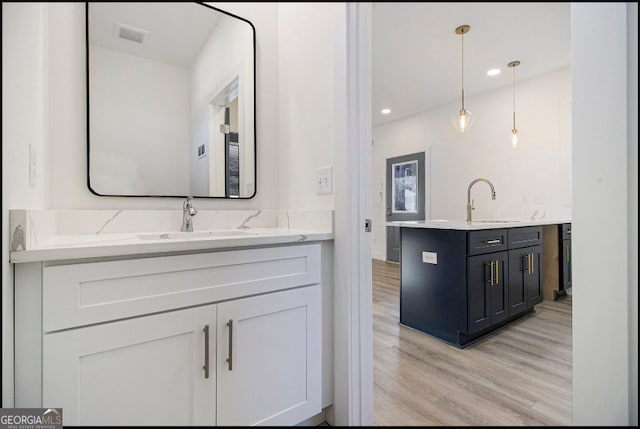 bathroom with vanity and wood-type flooring