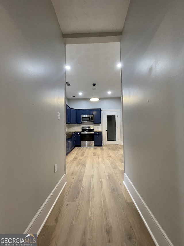 hall with light hardwood / wood-style flooring