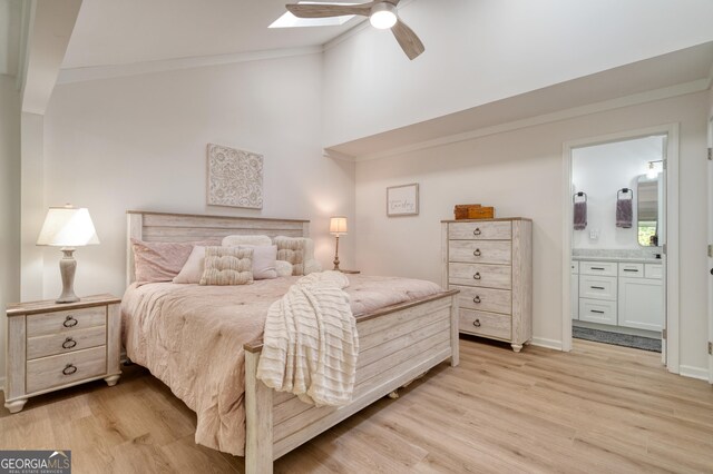 bedroom with ceiling fan, light hardwood / wood-style flooring, and ensuite bath