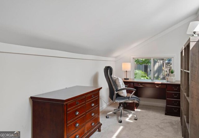 office featuring light carpet and vaulted ceiling