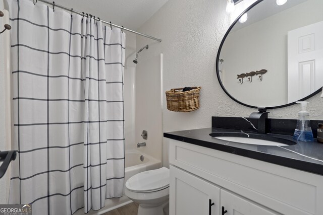 full bathroom featuring toilet, vanity, and shower / tub combo with curtain