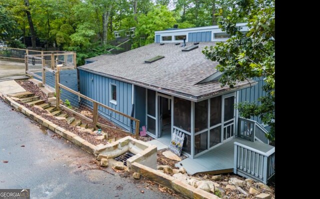 back of house featuring a sunroom