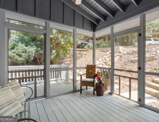 sunroom featuring vaulted ceiling with beams, wood ceiling, and a wealth of natural light