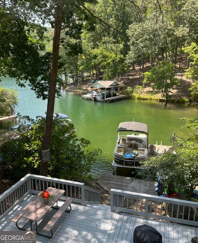 dock area featuring a deck with water view