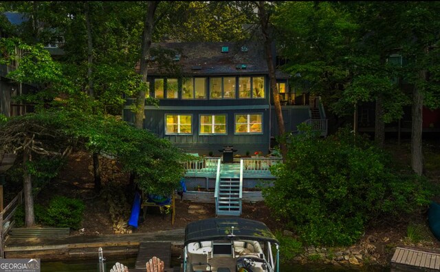 back of property featuring a wooden deck