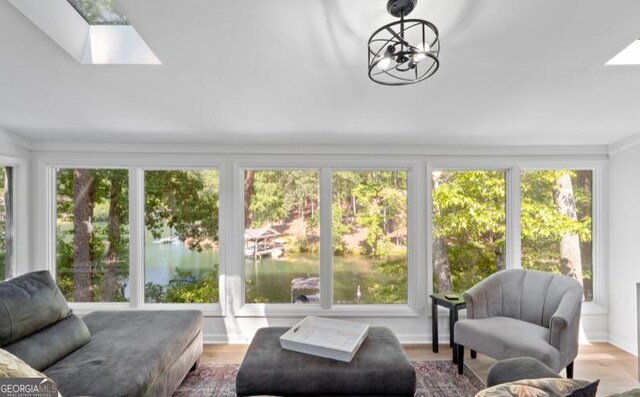 sunroom / solarium with a skylight and an inviting chandelier