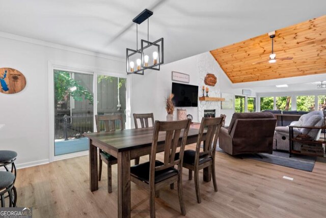 dining room with a wealth of natural light, light hardwood / wood-style flooring, and ceiling fan with notable chandelier