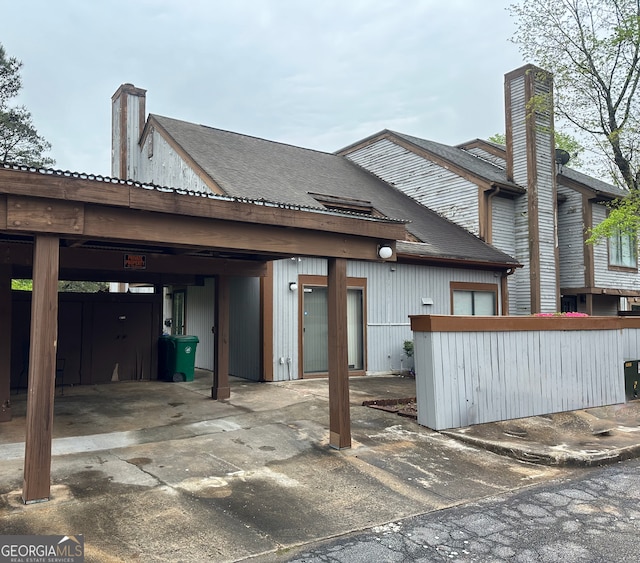 back of property featuring a carport