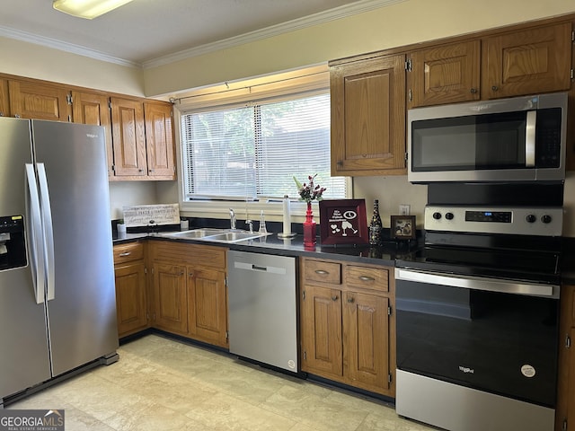 kitchen with sink, ornamental molding, and stainless steel appliances