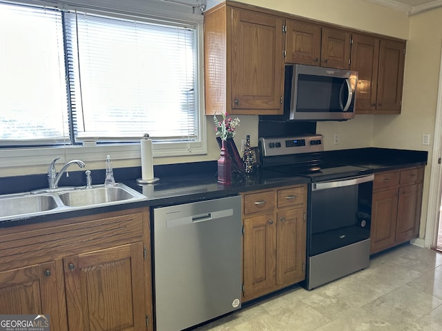 kitchen with a healthy amount of sunlight, appliances with stainless steel finishes, and sink