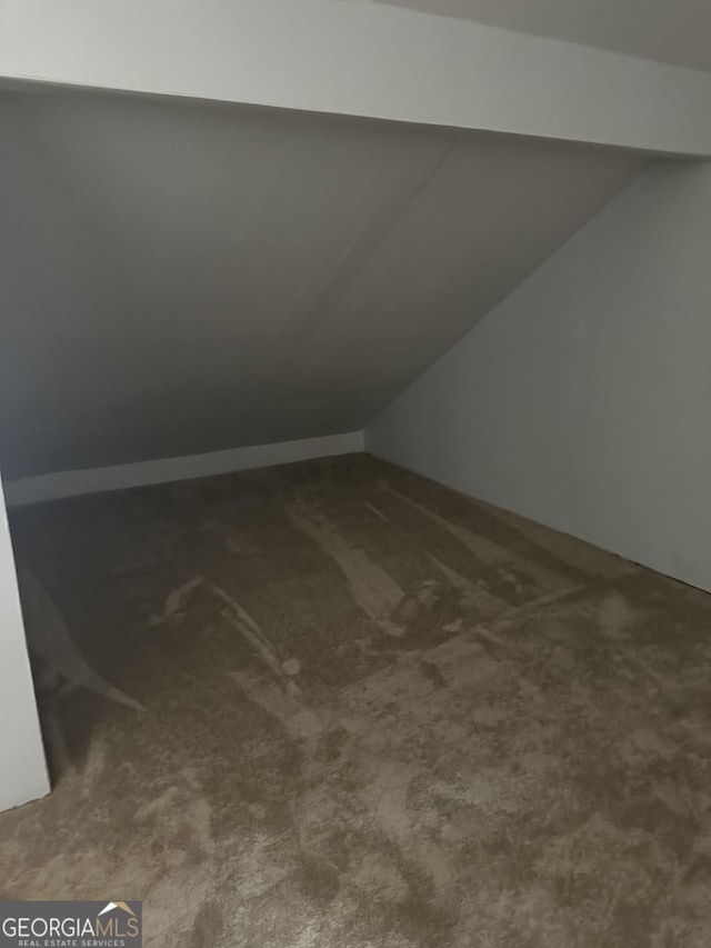 bonus room featuring carpet and lofted ceiling