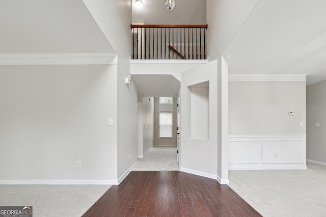 interior space featuring ornamental molding and carpet floors