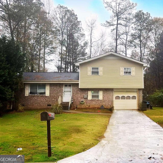 tri-level home with a garage and a front lawn