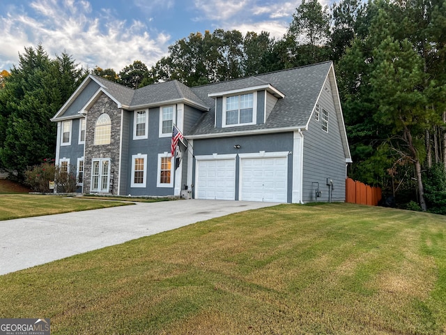 view of front facade with a garage and a front lawn