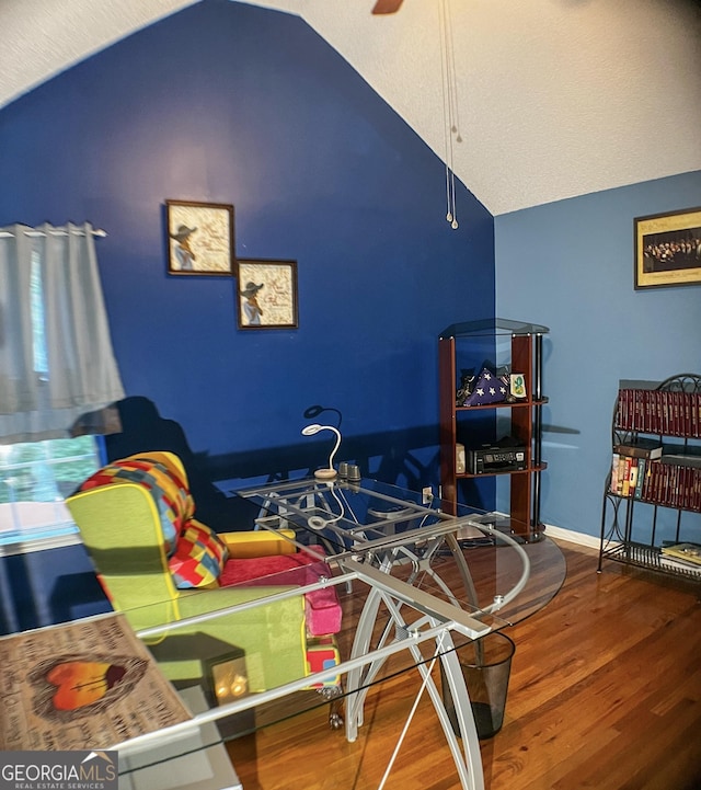 playroom featuring hardwood / wood-style flooring, vaulted ceiling, and ceiling fan