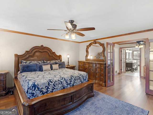 bedroom with ceiling fan, crown molding, and light hardwood / wood-style floors